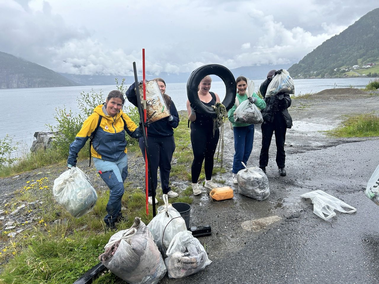 Fem personar som viser fram søppel som dei har samla. Foto: Stryn vgs